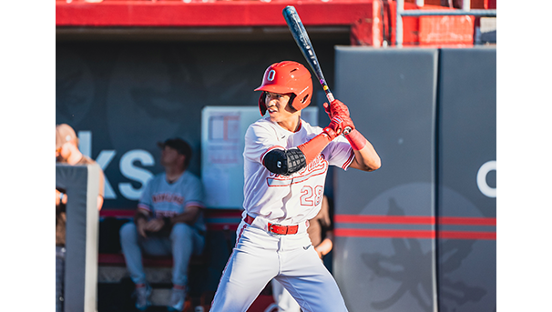 Ohio State baseball player holding a bat getting ready to swing while on home plate