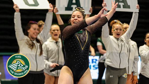 UAA Seawolf Gymnastics athletes compete as teammates cheer.