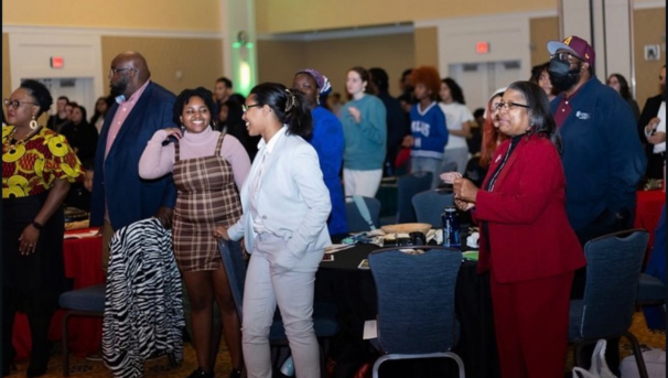Group of people standing around a table in Chandler Ballroom