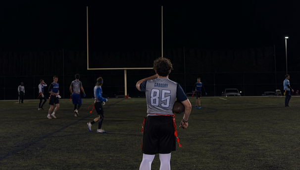 Football player standing holding the ball in his arm