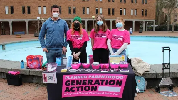 Four people safe sex tabling for Planned Parenthood Generation Action