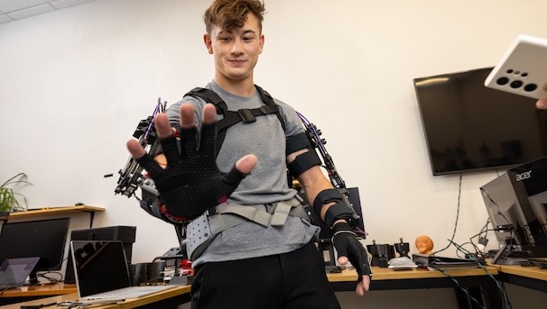 Student in an exoskeleton suit in the biomechatronics lab