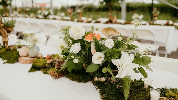Floral centerpieces along dinner table.