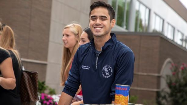 SGA leaders distribute food outside the student center