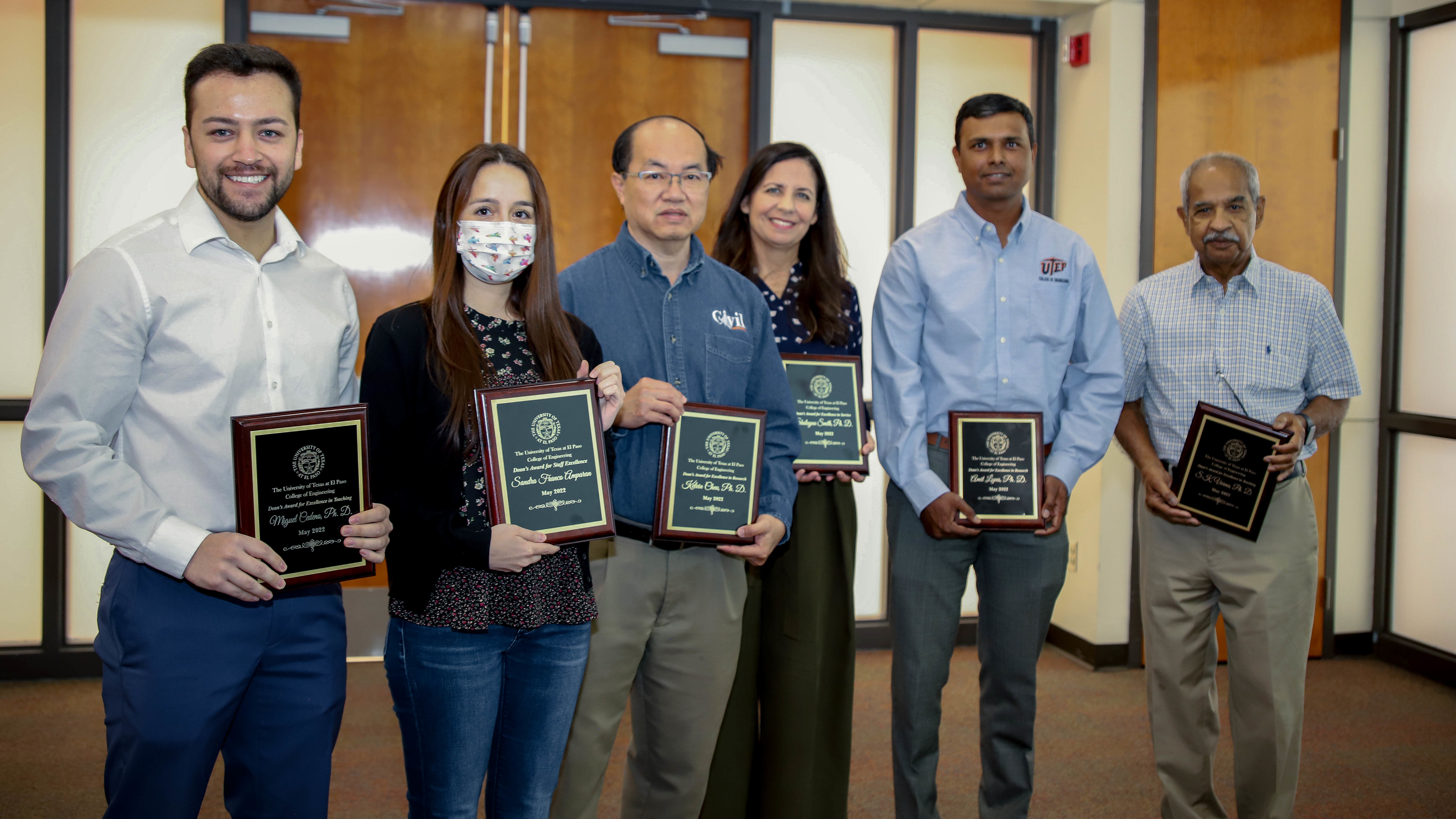 Group of six engineering faculty and staff holding their award plaques