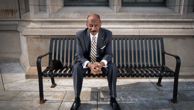 Dean Davis sitting on a bench outside of the Cathedral