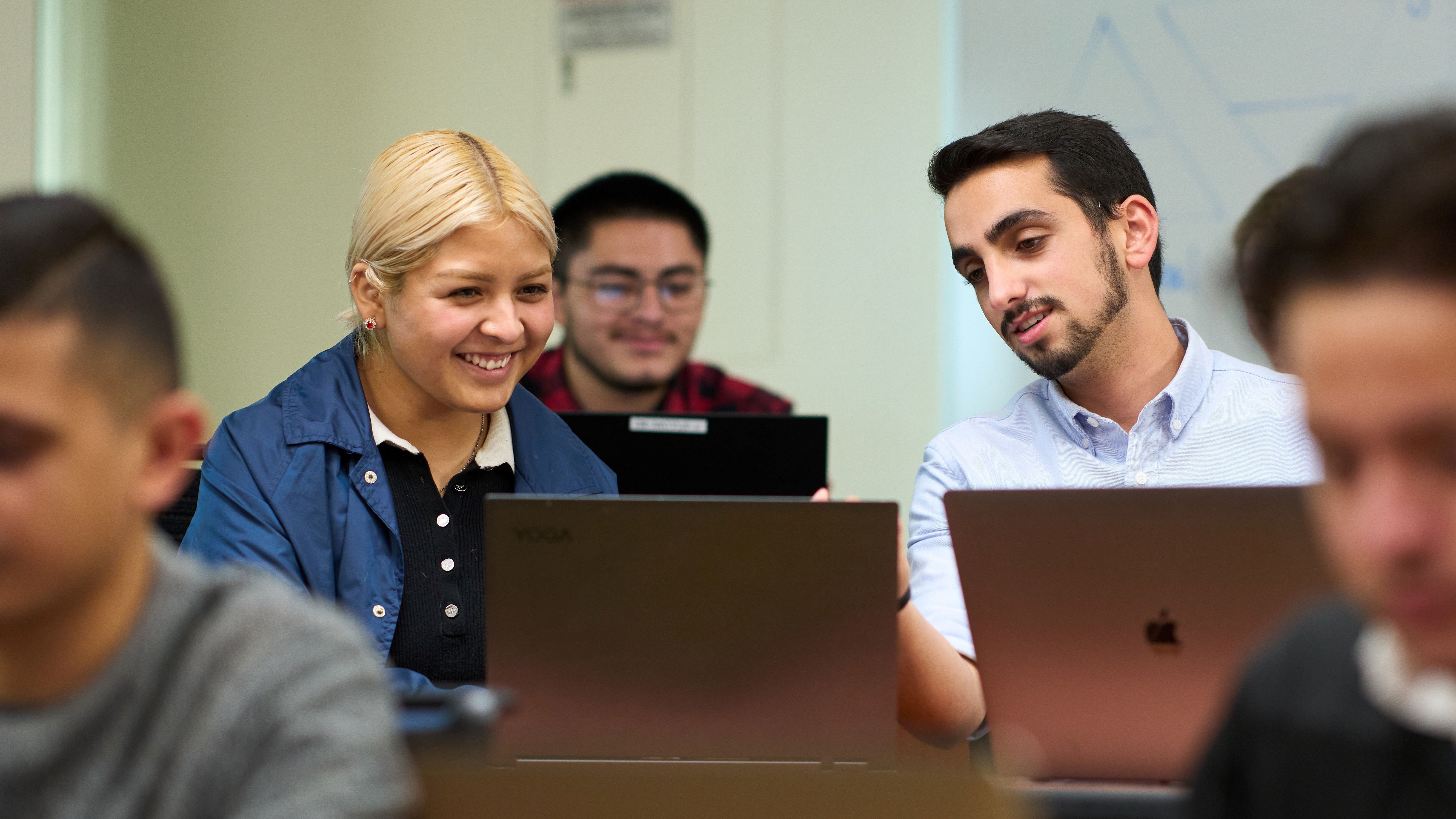 Students collaborating on laptops