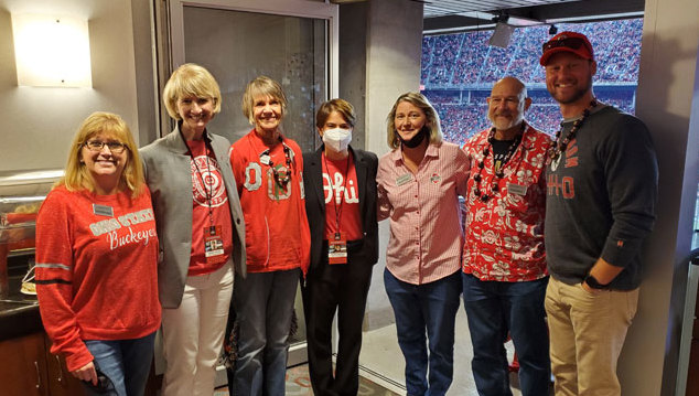 Ohio State Alumni Club of Greater Cleveland pose together at a box in the Shoe