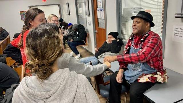 Individuals interacting with someone at the Father McKenna Center