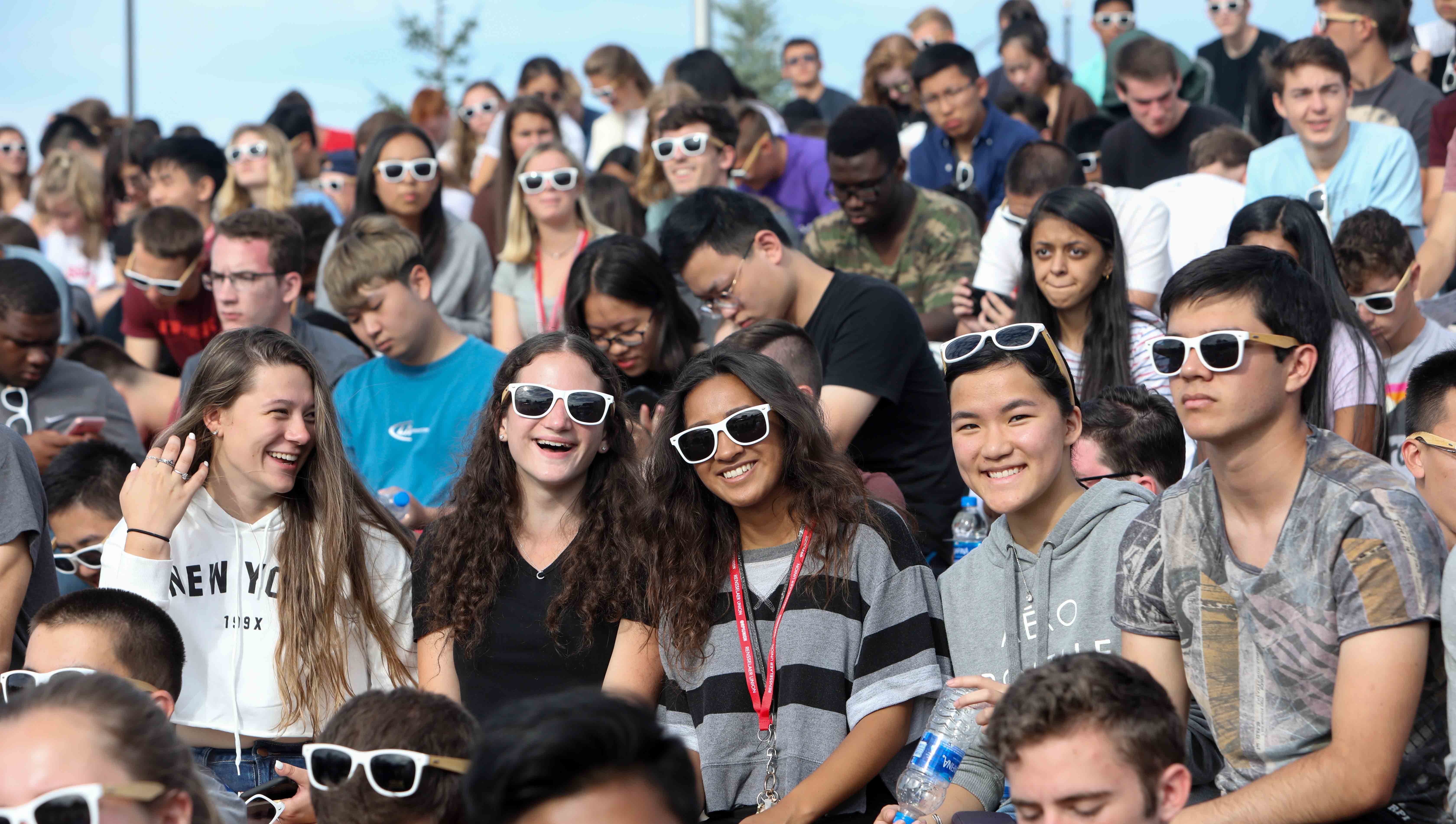 A large group of smiling students sitting outside during NRB.