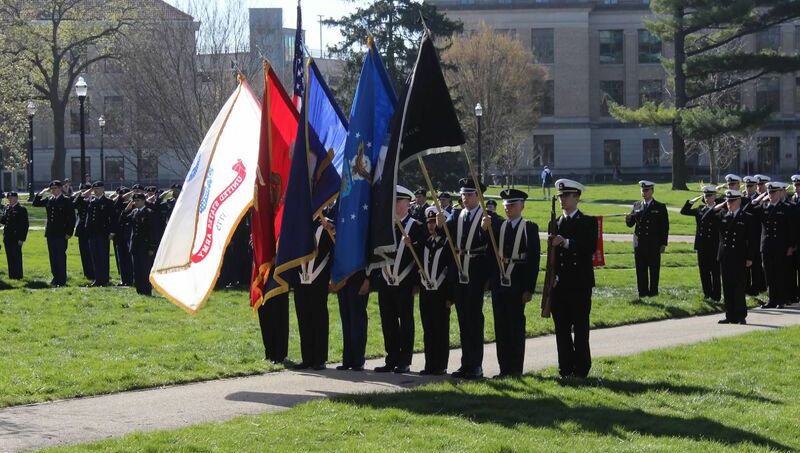 Various groups of soldiers with large flags salute on The Oval