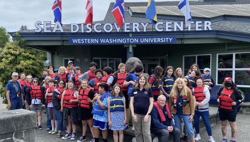 Students posing for a picture in front of SEA Discovery Center