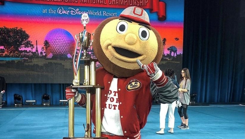 Brutus holding a trophy at the Walt Disney Resort Championship stage