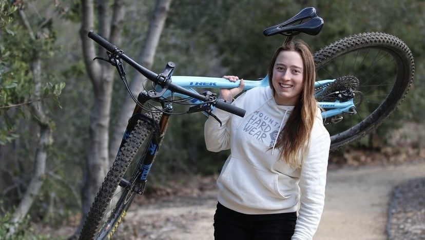 A member of the Cal Poly Cycling Club posing with a bike.