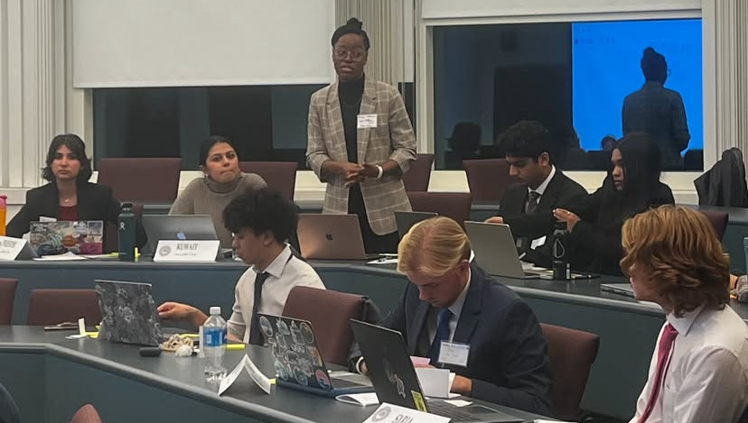 One standing student addressing a group of Model Diplomacy students.