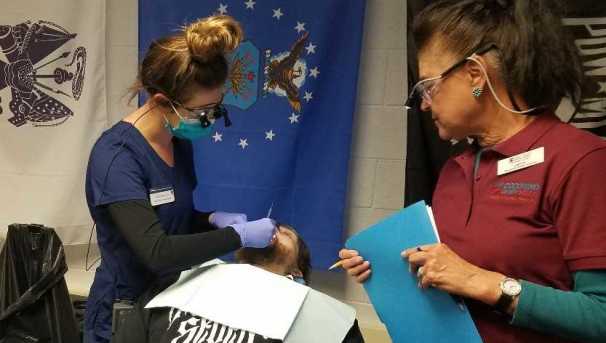 A dental hygienist student offers dental care to a veteran patient