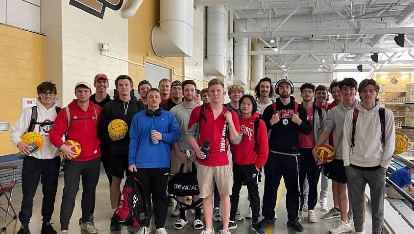 Group of individuals on the Ohio State men's water polo team standing indoors beside a pool