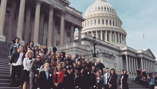 A large group of students standing on the steps of Capital Hill