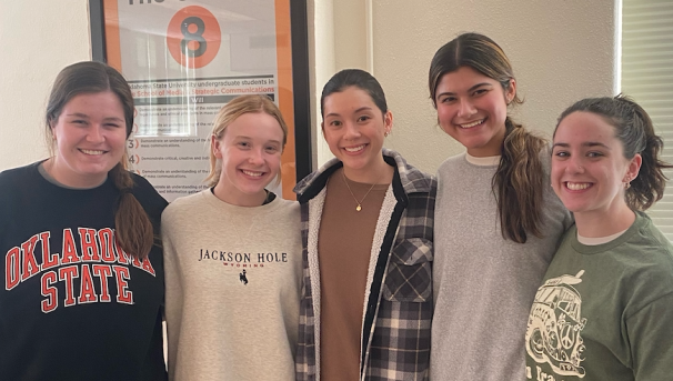 Five members of AWC smile for the camera