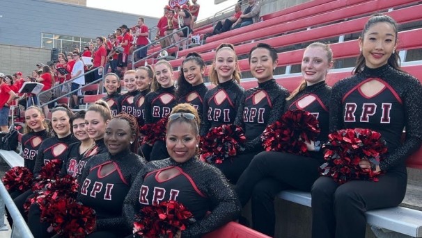 Members of the dance team sitting on the bleachers at ECAV