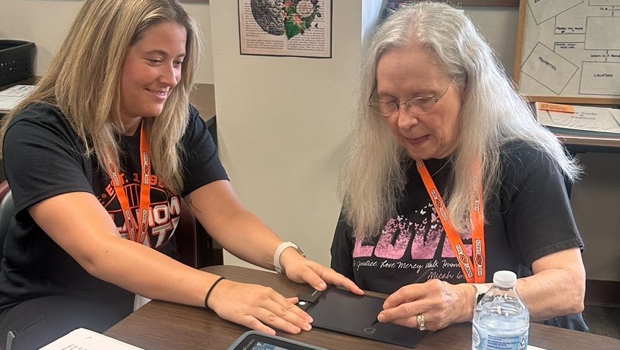 Maggie and Debbie practice written communication.