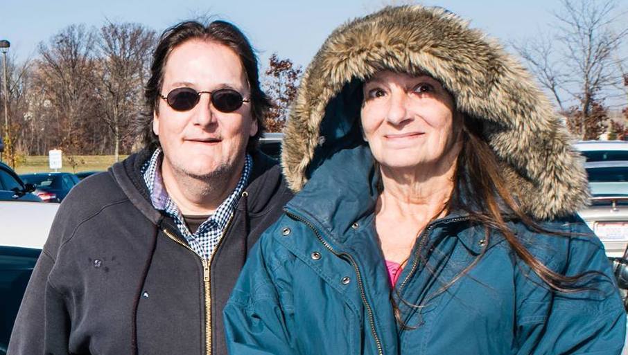 Jon & Laurie dressed for a winter's day, standing at the edge of a parking lot