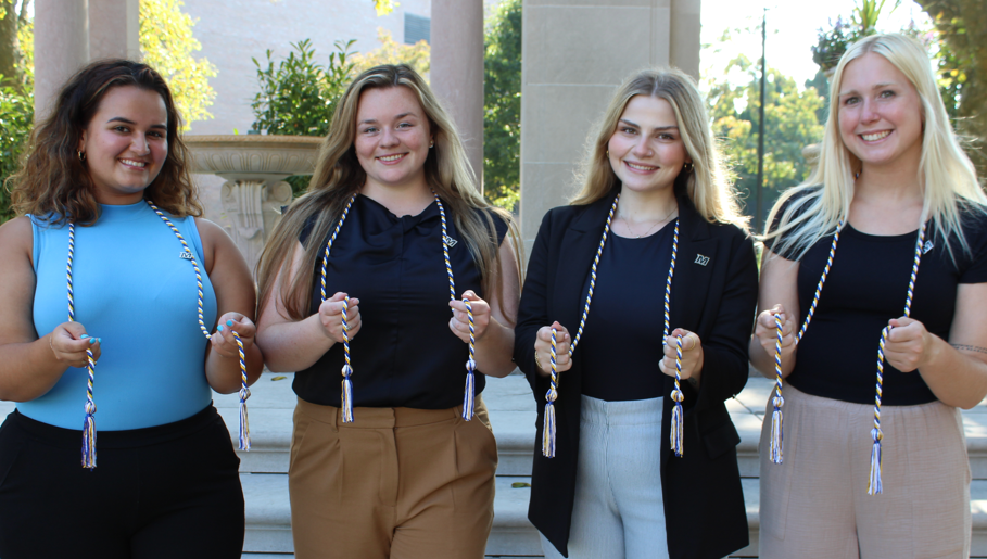 Class Officers in front of fountains wearing philanthropy cords