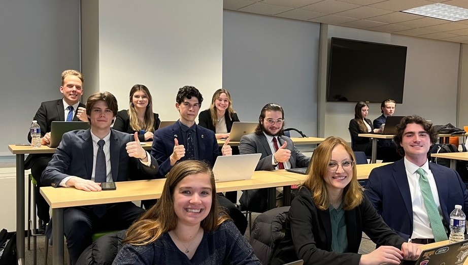 Members of Pi Sigma Epsilon sitting in a classroom