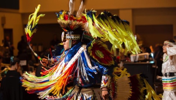 Native american dancing in traditional tribal outfit