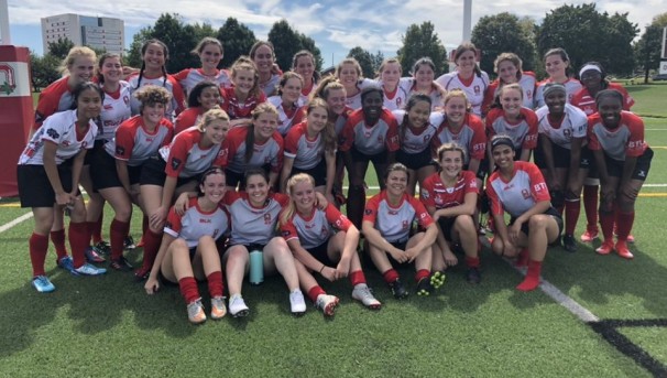 Ohio State Women's Club Rugby Team on a field, smiling at the camera