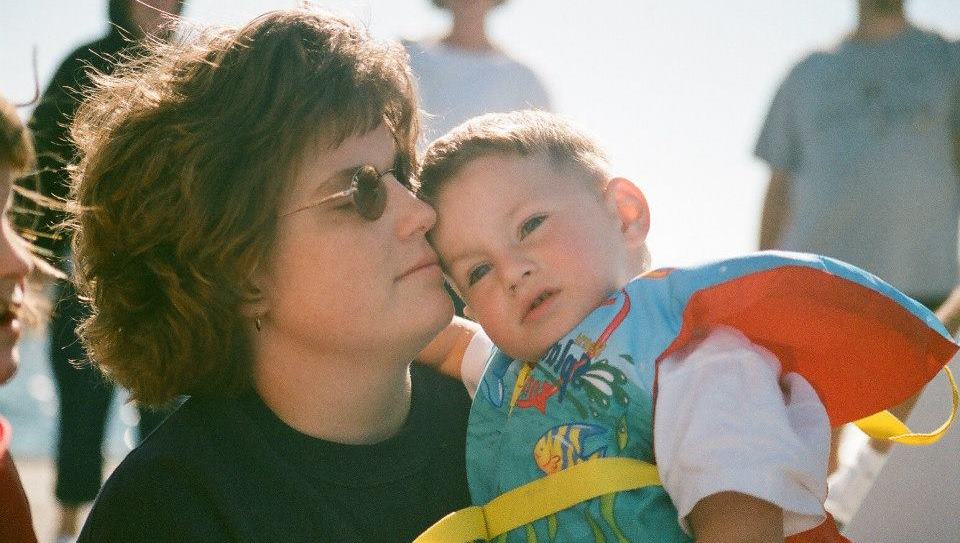 Barb holding her young son Kevin, who wears a blue and orange lifejacket.
