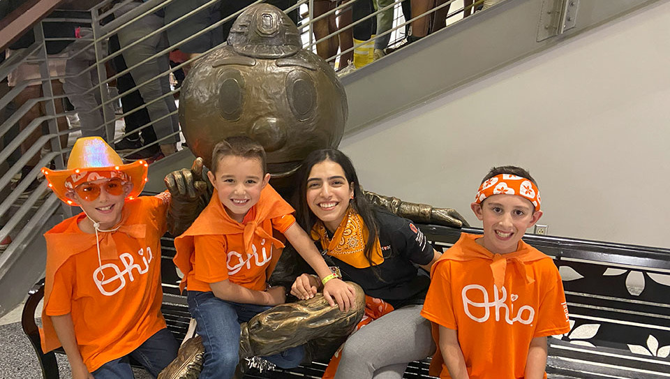 Three children and Sara sitting at the Bronze Brutus