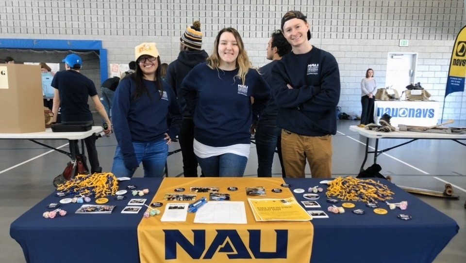 Three Blavin Scholars tabling a booth
