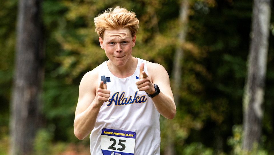 Men's Cross Country winner gives a thumbs up to photographer during 2023-24 season meet.