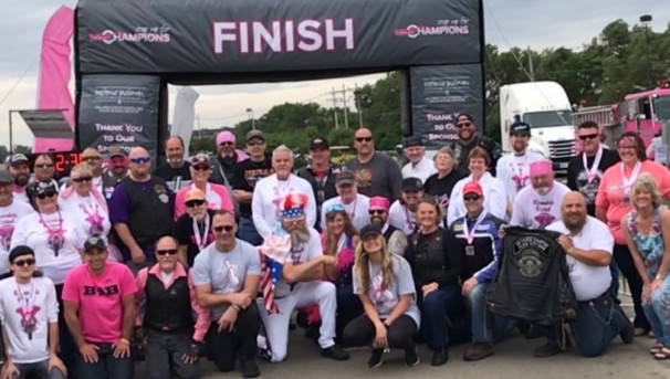 Rumble Road participants posed behind the finish line of the race