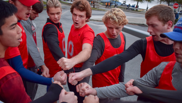 Members of the Crew Team put their fists in for a huddle