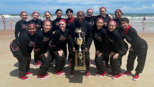 Members of the dance team with a trophy