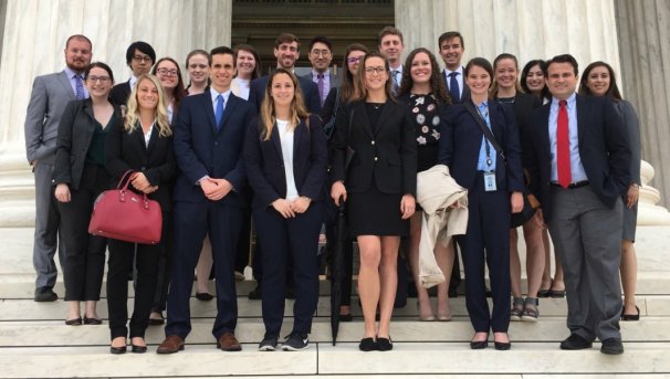 Buckeyes in Law at the Supreme Court stairs. They all wear formal attire