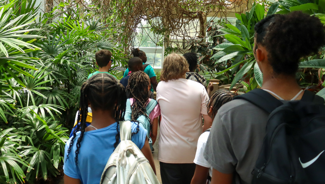 Young students surrounded by plants