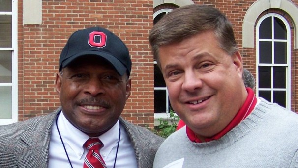 Photo of Scott Gale and Archie Griffin posed in front of a brick building