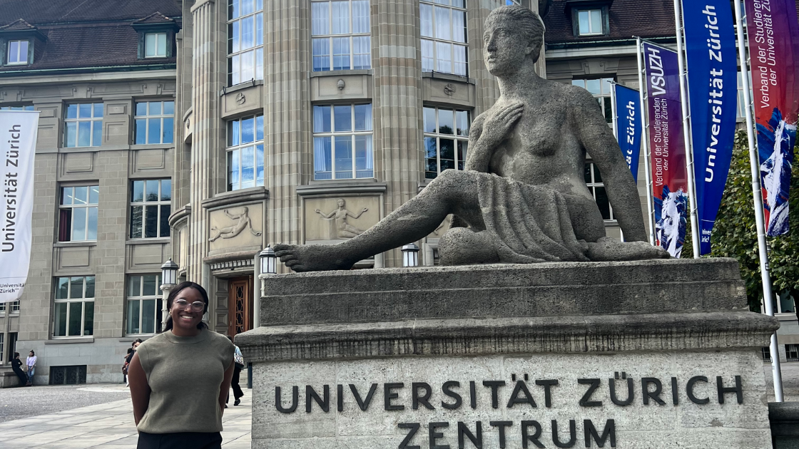 Student in front of statue while studying abroad