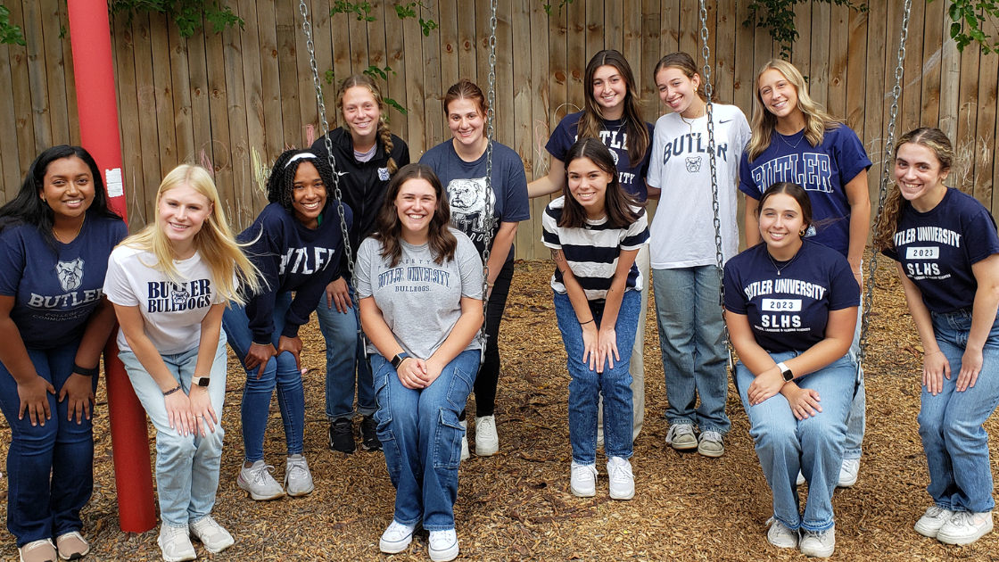 Students gathered on a swing set