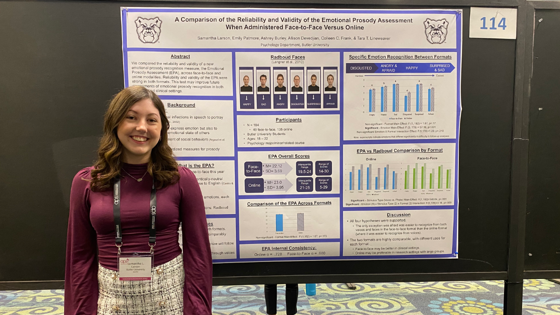 Student in front of their research presentation