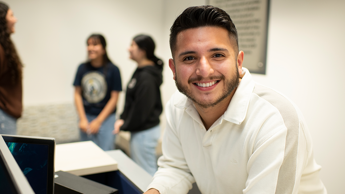Smiling student in classroom.