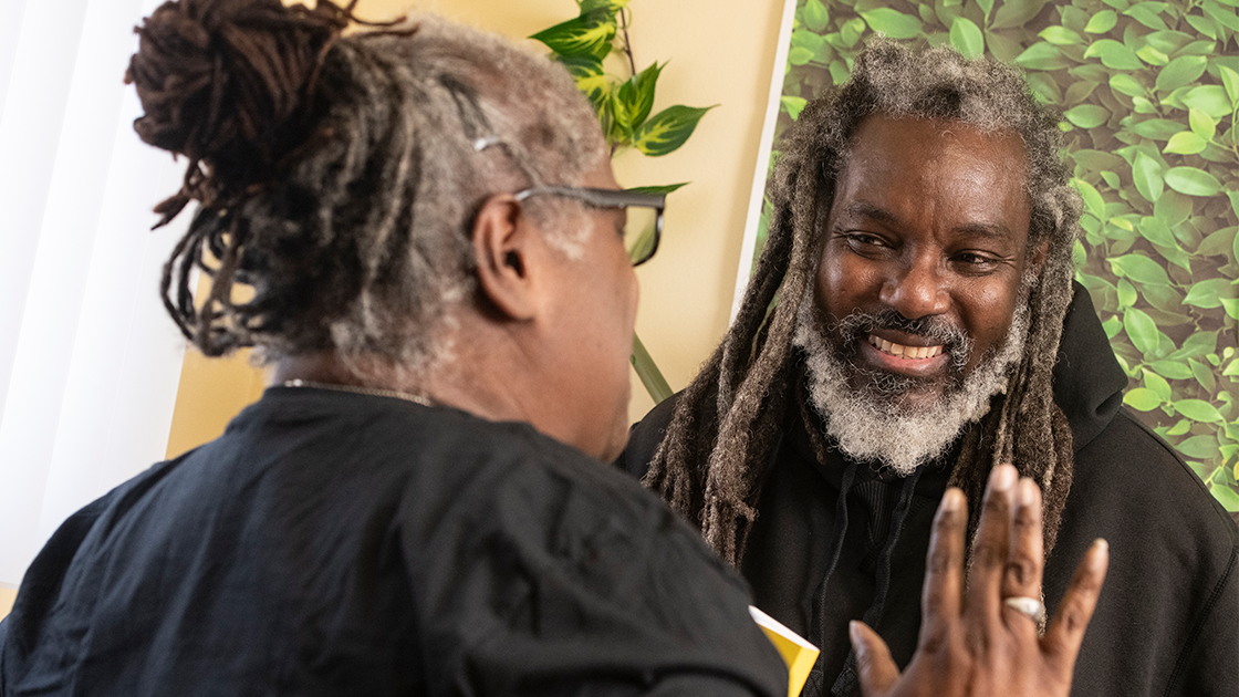 Group of students standing in front of a mural