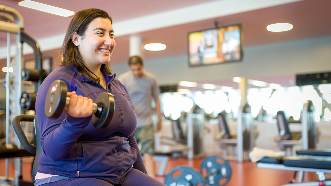 Person lifting weights in the gym.