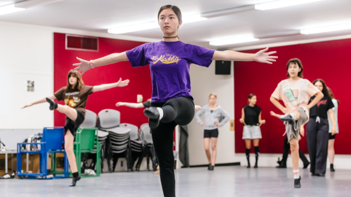 Students rehearsing a dance in a studio.