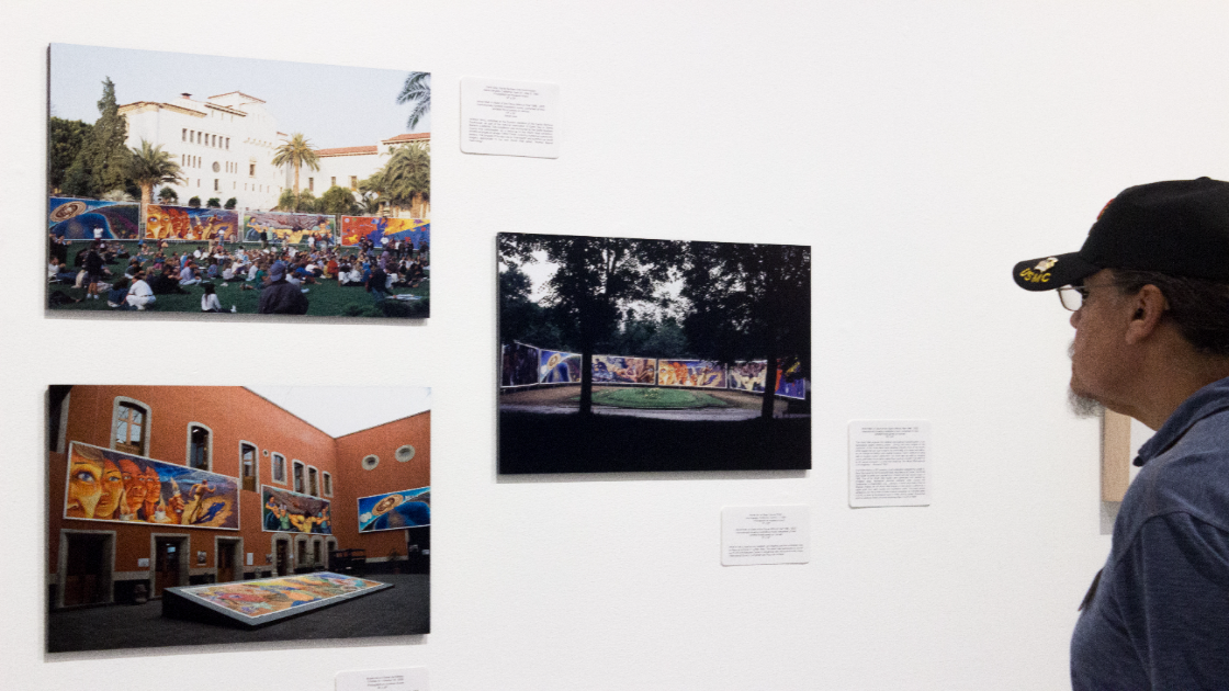 Arts Alumni Chapter visitor views artwork displayed in CSUN gallery exhibition.