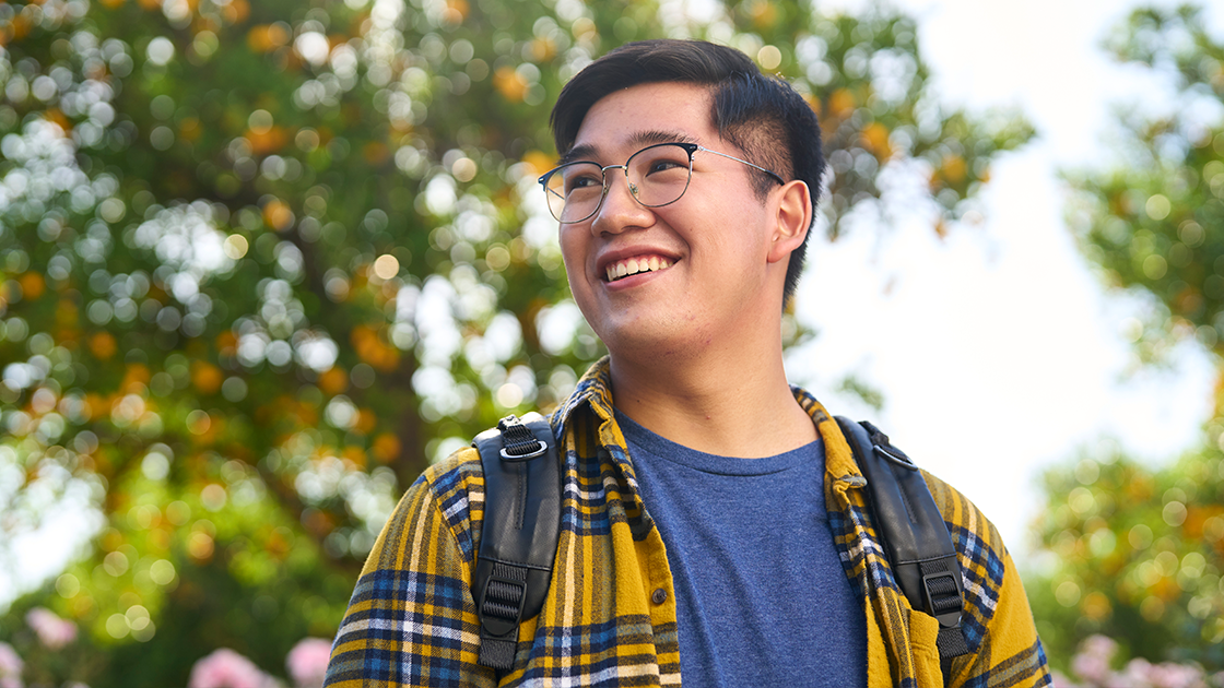 CSUN student smiles outdoors, reflecting pride, purpose, and a brighter future.