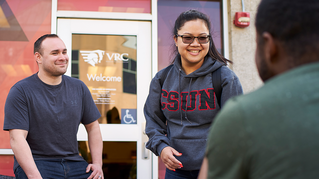 Group talking in front of the Veterans Resource Center.